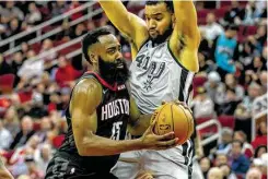  ??  ?? James Harden, driving on Trey Lyles, mirrored the Rockets om Monday by shaking off a dreadful start to finish strong with 28 points.