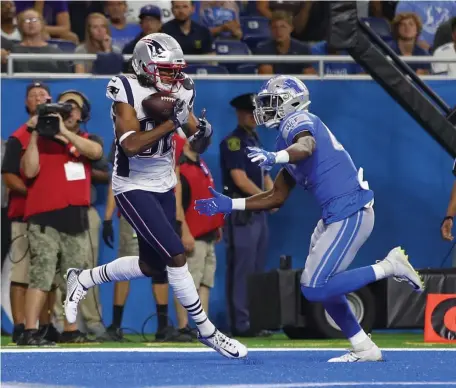  ??  ?? IN THE GRASP: Maurice Harris catches a touchdown pass during the Pats’ preseason win over the Lions.