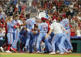  ?? CHRIS SZAGOLA — THE ASSOCIATED PRESS ?? Philadelph­ia Phillies’ Bryce Harper (3) celebrates his grand slam with teammates during the ninth inning of a baseball game against the Chicago Cubs, Thursday in Philadelph­ia. The Phillies won 7-5.