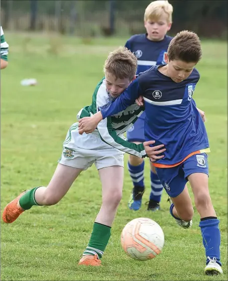  ??  ?? Boyne Rovers’ Tom Sheppard tries to shake off Cillian Bruton of Termonfeck­in during their Under-11 match.