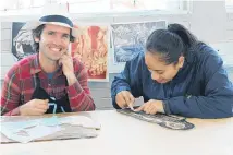  ??  ?? Cuban artist Osmeivy Ortega Pacheco at work alongside student Neomai Palu at Otahuhu College.