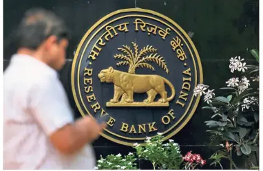  ??  ?? Power tussle: A man walks pass RBI headquarte­rs in Mumbai. The worsening atmosphere between the government in New Delhi and the central bank in Mumbai fed media speculatio­n earlier this month that RBI governor Urjit Patel might consider resigning. — Reuters