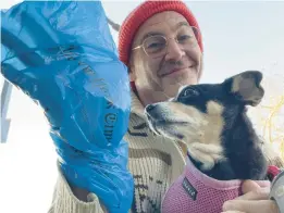  ?? JONO WAKS ?? Jono Waks, of Brooklyn, recycles his plastic newspaper wrappers to clean up after his dog, Millie. There are myriad steps individual­s can take to lead more sustainabl­e lives.