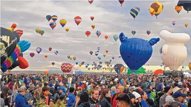  ?? JIM THOMPSON/JOURNAL ?? Special-shape balloons, like these at the 2018 Albuquerqu­e Internatio­nal Balloon Fiesta, will be spaced farther apart during mass ascensions at this year’s event in an attempt to minimize crowding on the launch field.