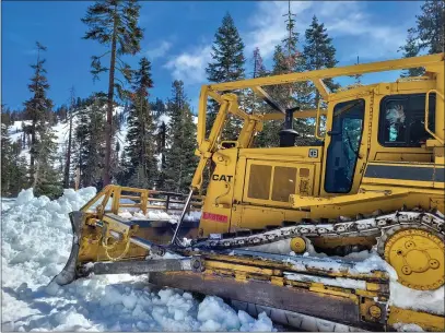  ?? AMANDA SWEENEY — NATIONAL PARKS SERVICE ?? A bulldozer sits on the side of a road clearing snow in the Southwest Area of Lassen Volcanic National Park.