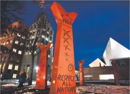  ??  ?? The Denver Art Museum sculpture “Wheel,” which was dedicated in 2005, sits at the Gio Ponti building’s north-facing entrance and references American Indian lodge and medicine wheel iconograph­y with its circle of red, forked tree forms. The sculpture,...