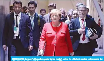  ?? —AFP ?? BUENOS AIRES: Germany’s Chancellor Angela Merkel (center) arrives for a bilateral meeting on the second day of the G20 Leadersí Summit in Buenos Aires yesterday.