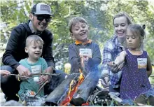  ?? CLIFFORD SKARSTEDT/EXAMINER ?? The Champagne family including Holden, 2, Elias, 5, Stella, 6, mom Christine and dad Mitch roast marchmallo­ws during the GreenUp 25th anniversar­y celebratio­n on Thursday at GreenUp Ecology Park. More than 300 people attended the festive event. See more...