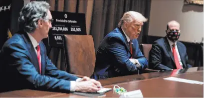  ?? Evan Vucci The Associated Press ?? President Donald Trump speaks Wednesday during a meeting with North Dakota Gov. Doug Burgum, left, and Colorado Gov. Jared Polis in the Cabinet Room of the White House. Trump called on governors across the nation to work to reopen schools.