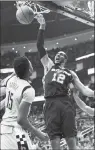  ?? Associated Press photo ?? San Antonio Spurs forward LaMarcus Aldridge (12) dunks as Houston Rockets centre Clint Capela (15) watches during the second half in Game 6 of an NBA basketball second-round playoff series, Thursday in Houston.