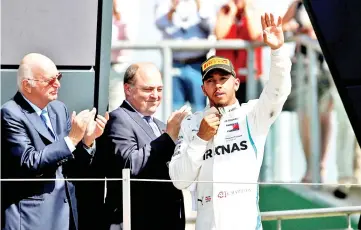  ?? — Reuters photo ?? Mercedes’ Lewis Hamilton celebrates second place on the podium after the race at the Silverston­e Circuit in Britain in this July 8 file photo.