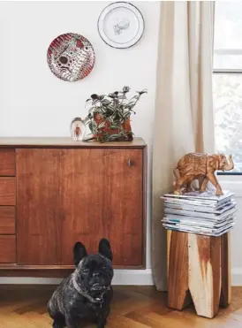  ??  ?? PATIO (above left) Outdoor sofa from Bunnings. LIVING AREA (above right) Walter Frog the French bulldog poses with the timber sideboard, found in an op-shop. KITCHEN (opposite) ‘Earth’ honed terrazzo tiles from Fibonacci Stone and Quantum Quartz benchtops in White Swirl from Gold Coast Marble &amp; Granite frame the view.