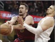  ?? TONY DEJAK — ASSOCIATED PRESS ?? Kevin Love, left, loses control of the ball against the Hawks’ Alex Len in the first half Oct. 21.