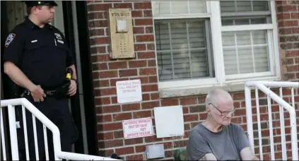  ?? AP PHOTO/SETH WENIG ?? James Shields, Sr. (right) sits in front of the building where his son and others were killed in the Queens borough of New York, on Tuesday. Police said the murder-suicide that left at least four people dead in New York City, may have stemmed from a...