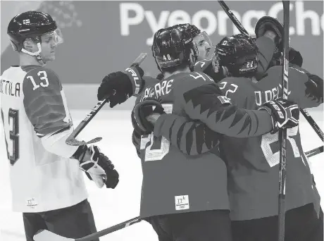  ?? LEAH HENNEL ?? Team Canada celebrates Montreal’s Maxim Noreau’s goal against Finland, the difference in a 1-0 victory.