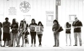  ?? Elizabeth Conley / Staff file photo ?? Attendees bow their heads in prayer during a candleligh­t vigil last year in honor of the one-year anniversar­y of the Santa Fe High School shooting.