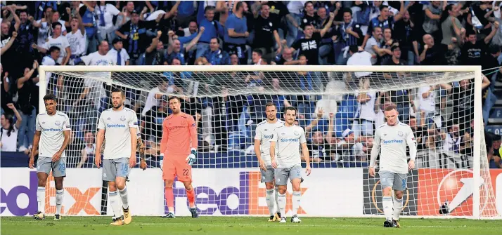  ??  ?? Grey day: Everton players show their disappoint­ment after Andrea Masiello’s opening goal for Atalanta while the home fans celebrate. Ronald Koeman’s team slumped to their third successive defeat last night