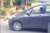  ?? ANI PHOTO ?? ■ A video grab of the cop being dragged on the bonnet of a car by the accused in Jalandhar on Saturday.