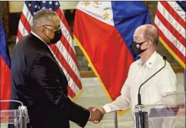  ?? Rolex dela Pena Pool Photo ?? U.S. DEFENSE Secretary Lloyd Austin, left, and his Philippine counterpar­t, Delfin Lorenzana, part ways after a meeting Friday in Quezon City, Philippine­s.