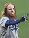  ?? Gregory Bull Associated Press ?? JUSTIN TURNER points to the Padres dugout after getting hit by a pitch in the sixth inning, sparking a rally.