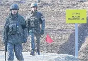  ??  ?? SMALL STEPS: South Korean soldiers walk at Arrowhead Ridge in the central section of the Korean border in Cheorwon, South Korea.