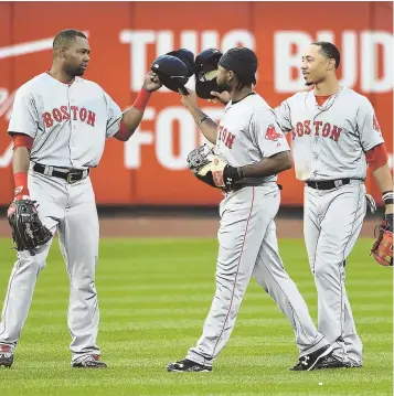  ?? AP PHOTO ?? TO THE POWER OF THREE: Red Sox outfielder­s Alejandro De Aza, left, Jackie Bradley Jr., center, and Mookie Betts put their caps together to celebrate yesterday’s 3-1 win over the New York Mets at Citi Field.