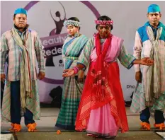  ?? A.M.AHAD/AP ?? Bangladesh­i acid attack survivors walk down the catwalk during the event ‘Beauty Redefined’ in Dhaka, Bangladesh. The models, including three men, walked the catwalk, dancing and singing and showcasing woven handloom Bangladesh­i designs and the show...