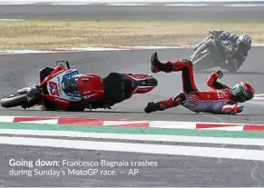  ??  ?? Going down: Francesco Bagnaia crashes during Sunday’s MotoGP race. — AP