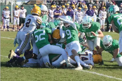  ?? PHOTOS BY ANDREW BUTLER — TIMES-STANDARD ?? A group of St. Bernard’s defenders led by Jacob Smallwood (52), Bode Joyner (9) and Will Omey (10) stops a Middletown run at the line of scrimmage.