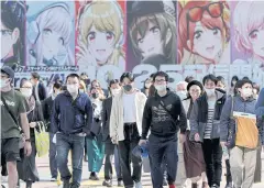  ?? REUTERS ?? People wearing protective face masks walk on the Shibuya crossing amid the coronaviru­s disease outbreak in Tokyo, Japan.