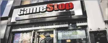  ?? ASSOCIATED PRESS ?? IN THIS JAN. 28 FILE PHOTO, pedestrian­s pass a GameStop store on 14th Street at Union Square, in the Manhattan borough of New York.