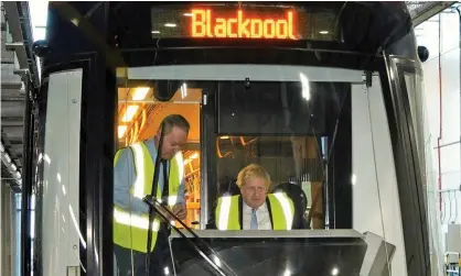  ?? ?? As Boris Johnson visits Blackpool bus depot, public transport plans have been scaled back with cuts to rail services and buses. Photograph: Reuters