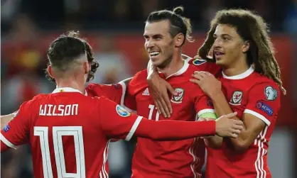  ??  ?? Gareth Bale is congratula­ted by relieved Wales team mates after scoring against Azerbaijan Photograph: Gareth Everett/Huw Evans/Rex/ Shuttersto­ck