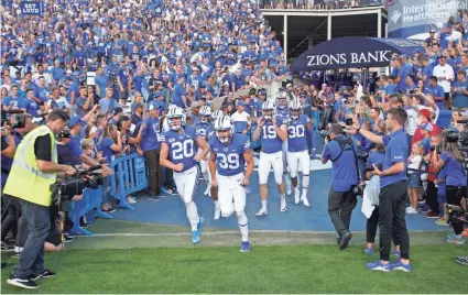  ?? GEORGE FREY/AP ?? BYU has a decades-long tradition of winning football, all-around athletic success and a worldwide following, as the educationa­l Mormon mecca.