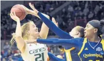  ?? STEPHEN DUNN/AP ?? Miami’s Leah Purvis is defended by Quinnipiac’s Jen Fay during their round NCAA Tournament game. first