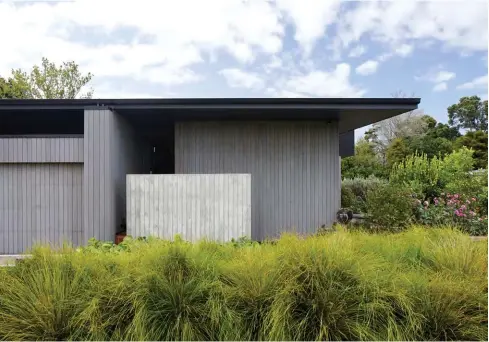  ??  ?? EXTERIOR The use of black for the roof is intended to make the material read as part form, part shadow, while the cast-in-place concrete wall was formed up using the cedar lining boards, so it appears as a concrete version of the timber cladding. “Another advantage of working for family is that you get to see the home in various lights, weather and seasons, and I love how it feels better each time I visit,” says Antony. “I think it’s a really lovely, quiet presence in the subdivisio­n; it doesn’t scream for attention. The front has a lack of windows as it’s south-facing; however, it’s single-storey when many are two, it’s respectful to the street and it generously offers space and garden to the public realm.”