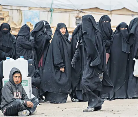  ??  ?? Refugees queue at the Internally Displaced Persons camp of al-hol in north-east Syria