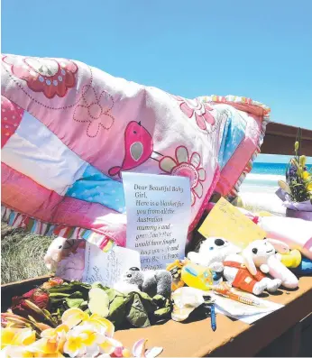  ??  ?? Tributes left near the Surfers Paradise beach where the body of a baby girl was discovered.