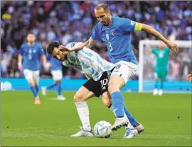  ?? Frank Augstein Associated Press ?? ARGENTINA’S Lionel Messi, left, and Italy’s Giorgio Chiellini vie for the ball during a match in June. Chiellini captained Italy to a European championsh­ip.