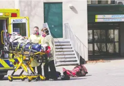  ?? JOHN MAHONEY FILES ?? Paramedics wheel a resident out of CHSLD Herron in Dorval on April 8, 2020. A total of 47 people at the facility died in the first wave of COVID-19.