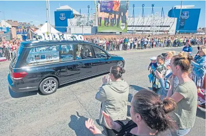  ?? Picture: PA. ?? The hearse passes the crowd which had gathered outside Goodison Park.