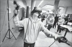  ?? @IMartensHe­rald Herald photo by Ian Martens ?? Michael Slovak, a Grade 9 student at Willow Creek Composite High School, plays a virtual reality game during the Merging Realities virtual reality conference Thursday at Lethbridge College.