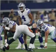  ?? AP PHOTO/ROGER STEINMAN, FILE ?? In this Aug. 18, 2018, file photo, Dallas Cowboys offensive guard Connor Williams (52) prepares for the snap along with quarterbac­k Dak Prescott (4) and center Joe Looney (73) during the first half of a preseason NFL football game against the Cincinnati Bengals in Arlington, Texas. Williams had arthroscop­ic knee surgery after getting hurt in the team’ loss to Tennessee and will miss at least one game. The Cowboys appear set to leave Looney at center for this week’s game against the Philadelph­ia Eagles. He’s been there all season in place of four-time Pro Bowler Travis Frederick, out with a nerve disorder. If Looney stays put, left guard will be filled by either Adam Redmond or Xavier Su’a-Filo.