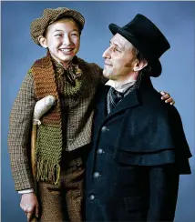  ?? COURTESY THE ALLIANCE THEATRE ?? Chloe Gia Bremer (left) as Tiny Tim and Andrew Benator as Ebeneezer Scrooge are part of a new adaptation of “A Christmas Carol” at the Alliance Theatre.