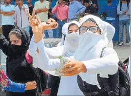  ?? PTI ?? Girl students throw stones at security forces during a clash in Pulwama on Tuesday.