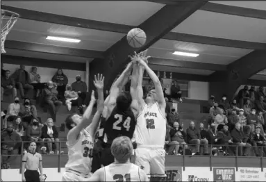  ?? Photo by Alexis Meeks ?? The Bismarck Lions and Centerpoin­t Knights fight for the ball on the rebound during Friday’s game at Holt Gymnasium.
