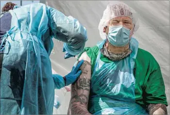  ?? Robert Gauthier Los Angeles Times ?? EMPLOYEE JOSEPH Kuresa gets vaccinated Wednesday at Homeboy Industries downtown. Clinic workers delivered the second doses to Homeboy personnel who got their first dose in March.