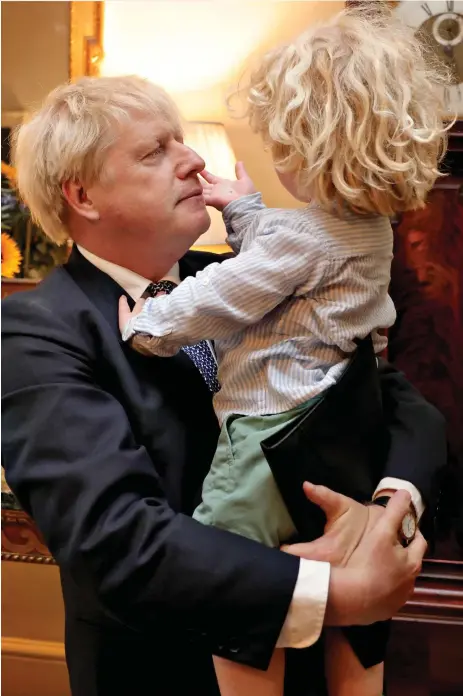  ?? ?? Heir to hair: Boris Johnson shares a tender moment in Downing Street yesterday with his son Wilf