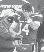  ?? ANDREWMILL­S / AP ?? Jets quarterbac­k Sam Darnold reacts on the sideline after throwing an intercepti­on, his second of the game, in the fourth quarter against the Dolphins on Sunday.