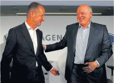  ?? /Reuters ?? Partners: Volkswagen CEO Herbert Diess, left, and Ford president and CEO Jim Hackett say the latest collaborat­ions on electric and selfdrivin­g vehicles could save hundreds of millions of dollars for each company.